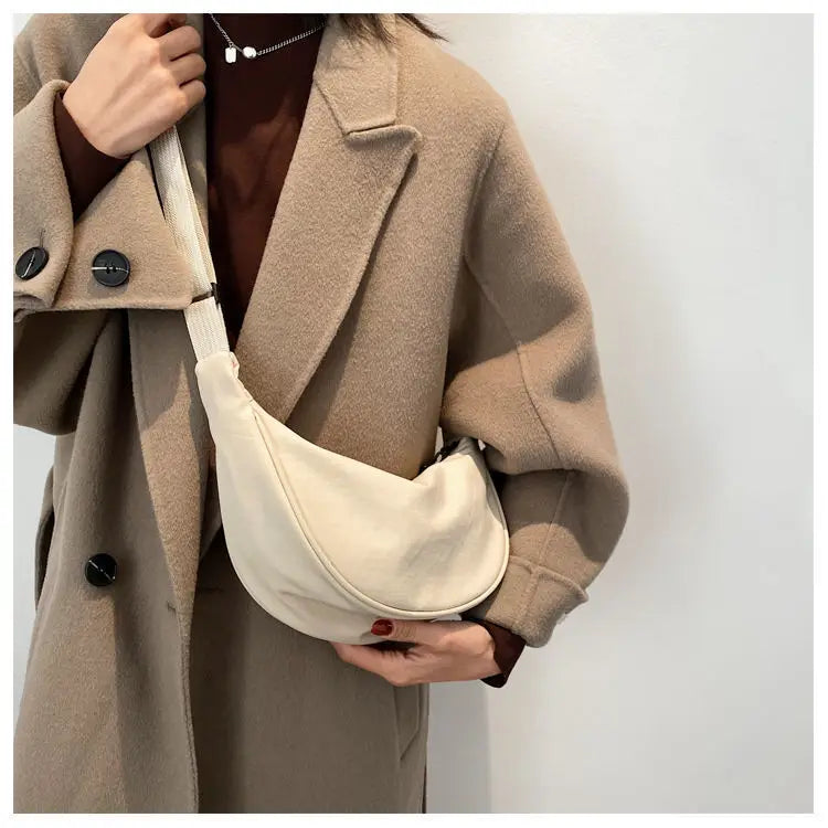 Women's bag - A round-shaped nylon bag with a cross-body strap, suitable for traveling, going to school or shopping.