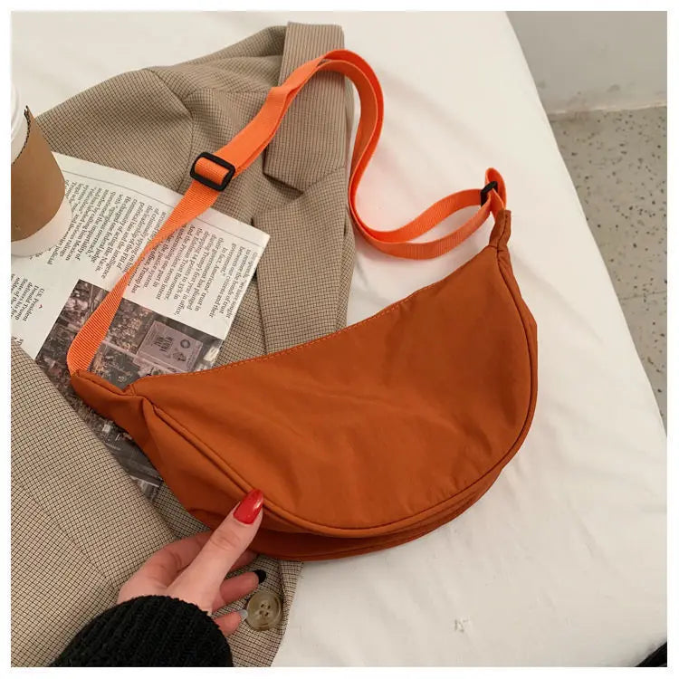 Women's bag - A round-shaped nylon bag with a cross-body strap, suitable for traveling, going to school or shopping.